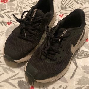 Worn but still in good condition. Nike Revolution black sneakers